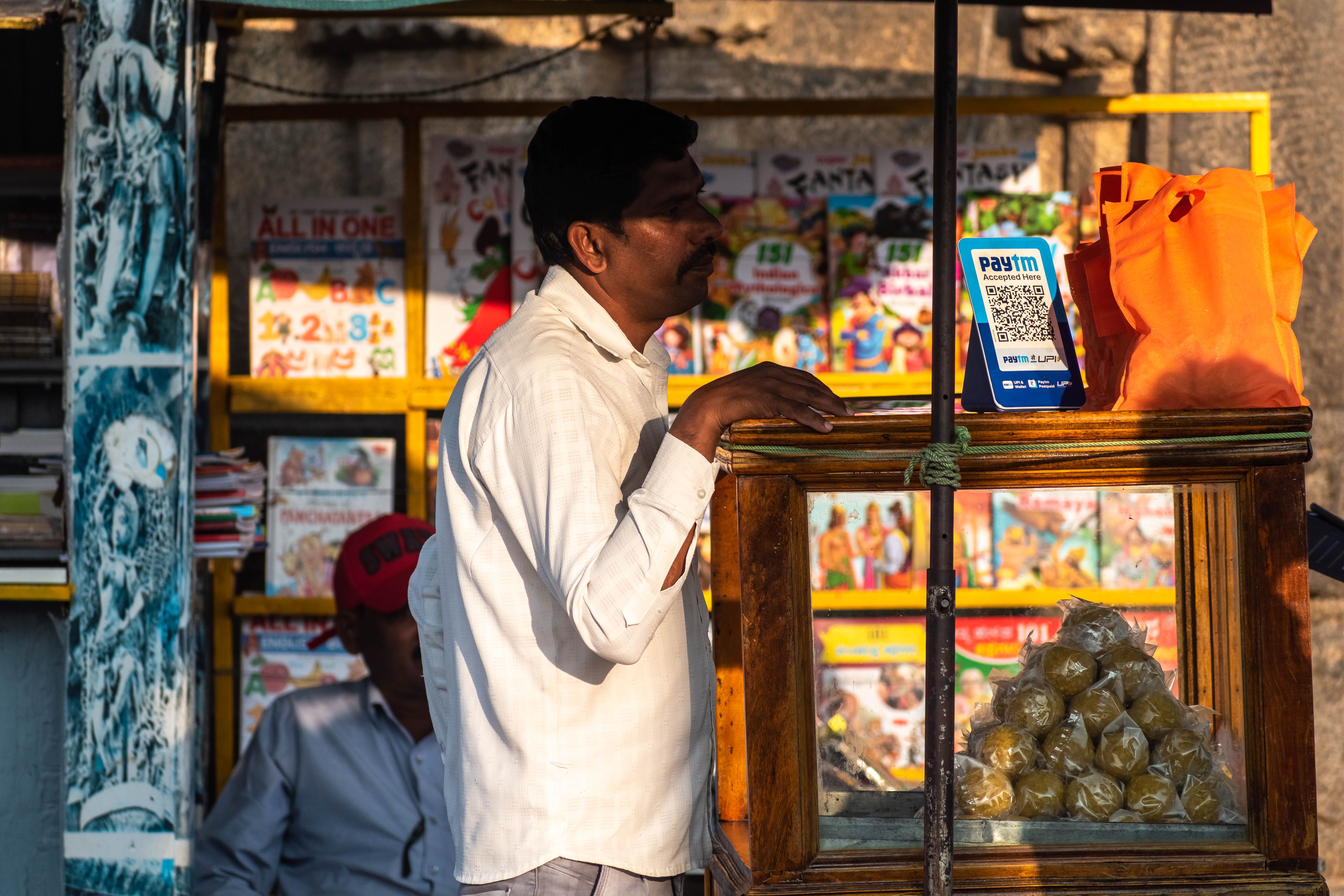 An Indian street vendor with a paytm upi QR cod